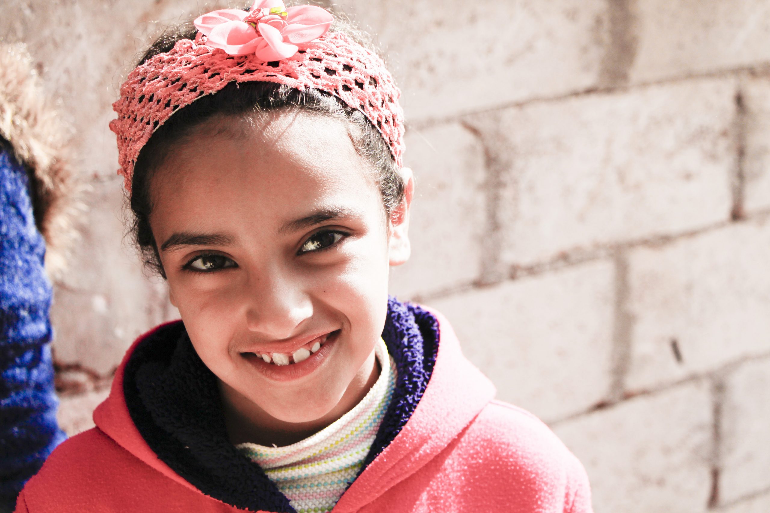 little girl smiling icmc Migrants and Refugees